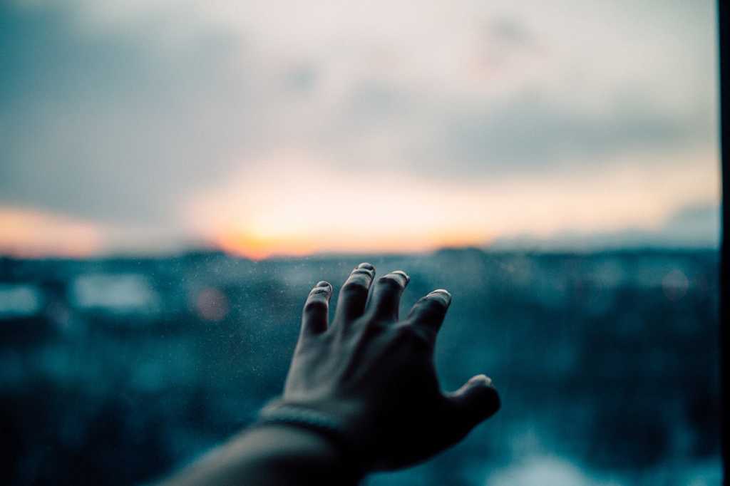 a hand reaches toward the horizon [future/goals/efforts/attempts/persistence/endurance]