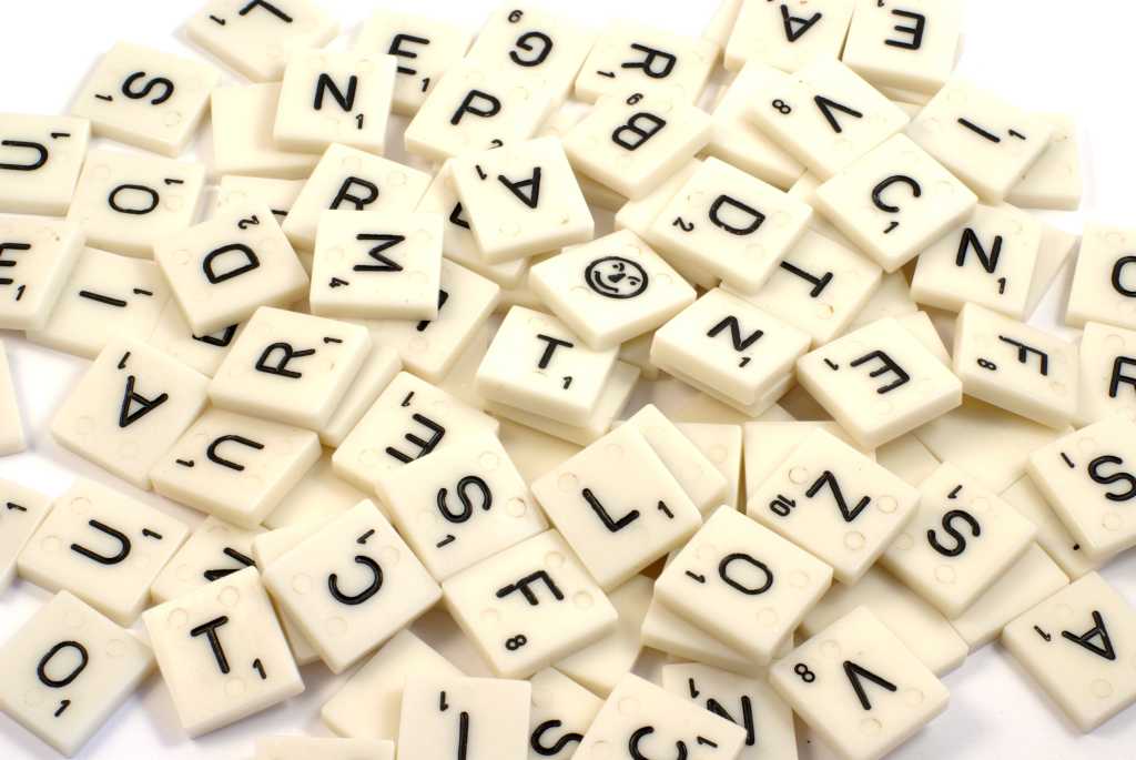 pile of scrabble pieces 100922332