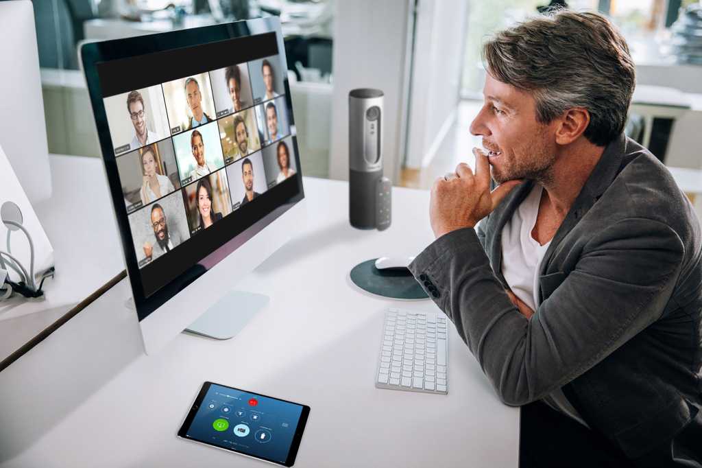 Zoom video conferencing  >  One user connected via laptop showing a grid of remote participants.